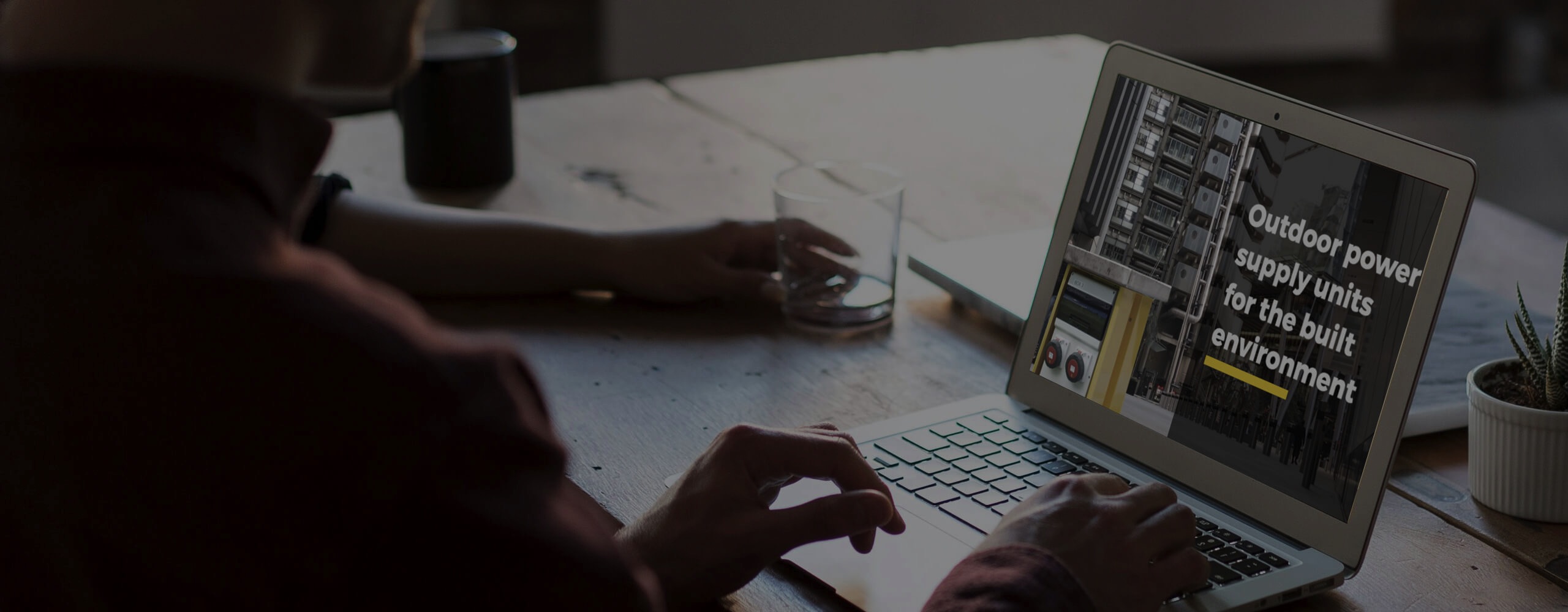 Image of a person viewing a laptop that shows the Pop Up Power Supplies Ltd website